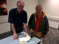 Keith Basterfield signing his book, Close Encounters of an Australian Kind, for Patrick Daluz at workshop on the 3 July at Ryde Eastwood Leagues Club